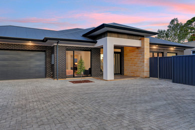 Inspiration for a large modern two-story exterior home remodel in Adelaide