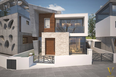 Large modern white two-story concrete exterior home idea in Other