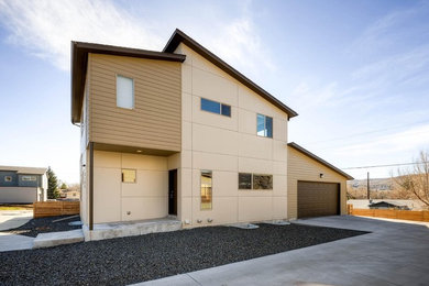 Mid-sized minimalist beige two-story concrete fiberboard duplex exterior photo in Denver with a shed roof and a shingle roof