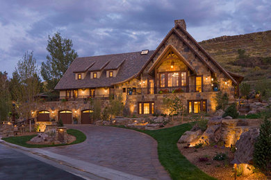Three-story stone exterior home idea in Denver