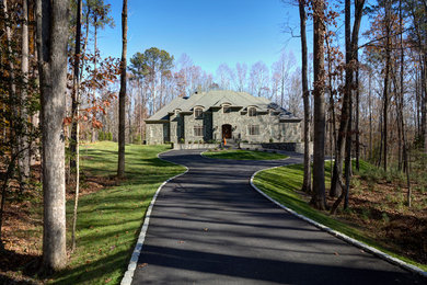 Huge elegant gray two-story stone exterior home photo in Richmond with a clipped gable roof