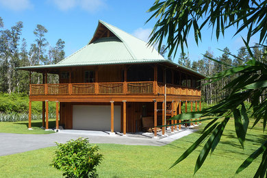 Example of an island style two-story gable roof design in Hawaii