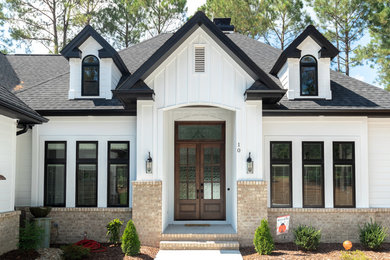 Example of a mid-sized transitional white one-story wood house exterior design in Raleigh with a hip roof and a shingle roof