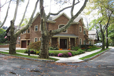 Inspiration for a large contemporary two-story brick gable roof remodel in New York