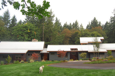 Example of a mid-sized trendy two-story mixed siding gable roof design in Portland