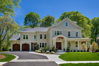 Large elegant beige two-story wood gable roof photo in Boston