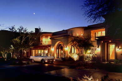 Inspiration for an expansive and beige mediterranean two floor house exterior in Phoenix.