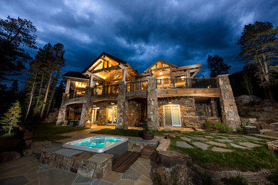 Inspiration for a mid-sized rustic brown two-story wood exterior home remodel in Denver with a shingle roof