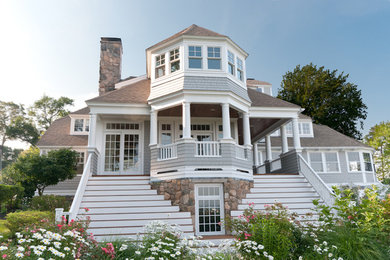 Example of a mid-sized transitional gray two-story wood exterior home design in Boston with a hip roof