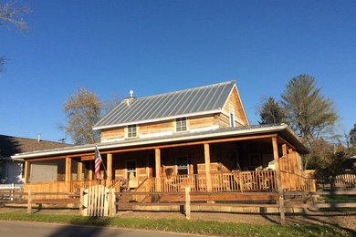 Large farmhouse brown two-story wood house exterior idea in Indianapolis with a hip roof