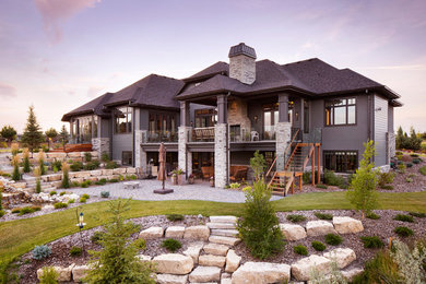 Example of a large mountain style multicolored two-story mixed siding house exterior design in Calgary with a hip roof and a shingle roof