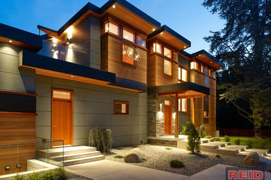 Ejemplo de fachada de casa gris moderna grande de dos plantas con revestimientos combinados, tejado de metal y tejado de un solo tendido
