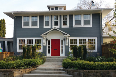 Example of a large classic blue two-story wood exterior home design in Portland with a hip roof