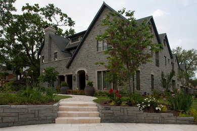 Design ideas for a traditional house exterior in Houston with stone cladding.