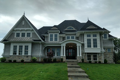 Inspiration for a large gray two-story mixed siding exterior home remodel in Other with a shingle roof
