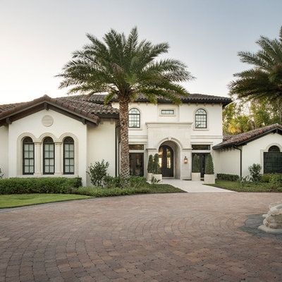 Tuscan beige two-story exterior home photo in Orlando with a tile roof