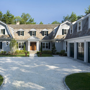Design ideas for a large traditional two-storey brown house exterior in Boston with wood siding, a gambrel roof and a shingle roof.