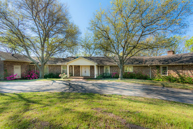 Inspiration for a red traditional bungalow brick house exterior in Austin.