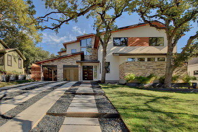 Mid-sized elegant beige two-story mixed siding house exterior photo in Austin with a shed roof and a metal roof