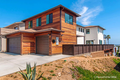 Inspiration for a mid-sized modern two-story mixed siding exterior home remodel in San Diego with a hip roof