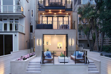 Contemporary gray three-story stucco flat roof idea in San Francisco