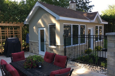 Inspiration for a mid-sized contemporary beige one-story stone gable roof remodel in Ottawa