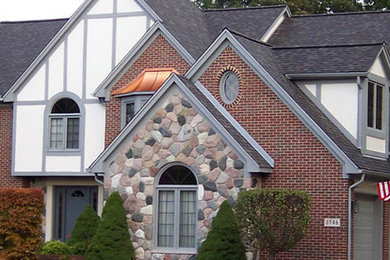Mid-sized elegant multicolored two-story mixed siding exterior home photo in Detroit with a shingle roof