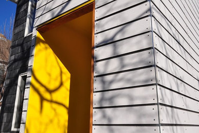Inspiration for a contemporary gray concrete fiberboard exterior home remodel in Kansas City