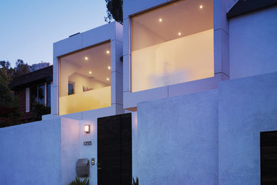 Small modern white two-story stucco flat roof idea in Los Angeles