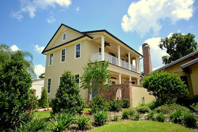Example of a mid-sized mountain style yellow two-story concrete fiberboard exterior home design in Orlando