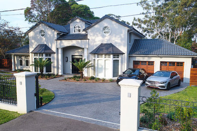 Photo of a large modern two floor detached house in Sydney with a tiled roof.