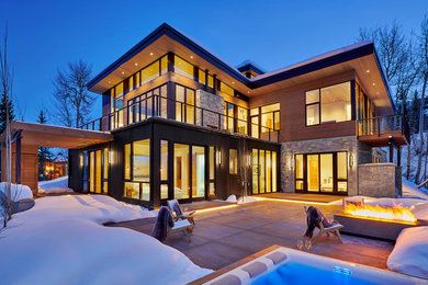 Diseño de fachada de casa multicolor actual grande de dos plantas con revestimiento de madera, tejado plano y techo verde