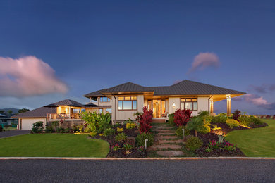 Example of a mid-sized island style beige two-story glass exterior home design in Hawaii
