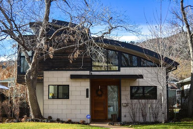 This is an example of a medium sized and gey contemporary two floor detached house in Denver with mixed cladding, a lean-to roof and a metal roof.