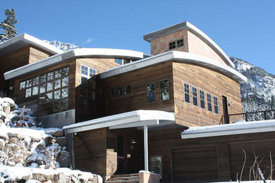 Inspiration for a large rustic brown three-story mixed siding exterior home remodel in Denver