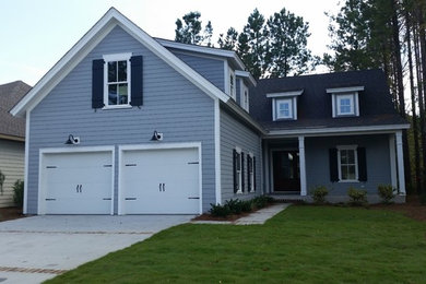 Example of a mid-sized beach style blue two-story vinyl exterior home design in Atlanta