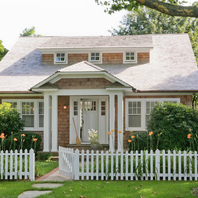 Elegant wood exterior home photo in New York with a clipped gable roof