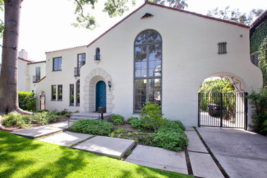 Inspiration for a large transitional white two-story stucco gable roof remodel in Los Angeles