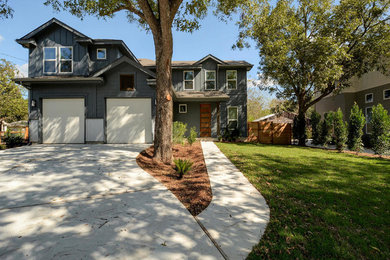 Large minimalist gray two-story mixed siding exterior home photo in Austin with a clipped gable roof