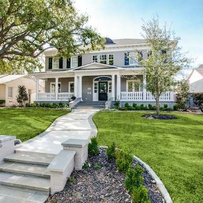 Example of a large classic gray two-story brick house exterior design in Dallas with a hip roof and a shingle roof