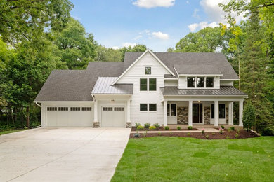 Large transitional white two-story concrete fiberboard exterior home photo in Minneapolis with a mixed material roof