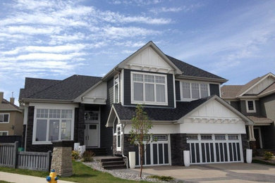 Photo of a large and blue classic two floor house exterior in Calgary with wood cladding.