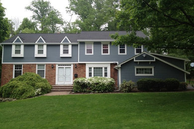 Example of a large classic blue two-story concrete fiberboard gable roof design in New York