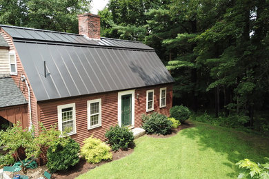 Photo of a two floor detached house in Boston with a metal roof.