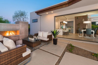 Example of a mid-sized trendy beige one-story stucco exterior home design in Phoenix