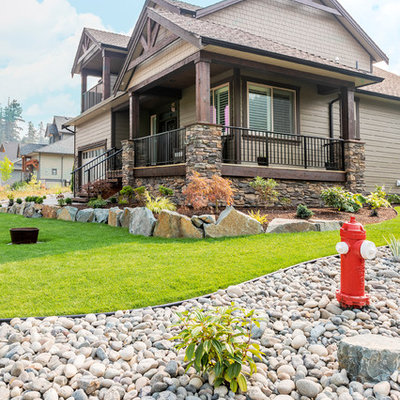Example of a large classic beige two-story concrete fiberboard house exterior design in Vancouver with a clipped gable roof and a shingle roof