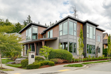 Inspiration for a large contemporary green two-story mixed siding flat roof remodel in Seattle