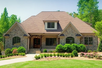 Traditional stone exterior home idea in Raleigh