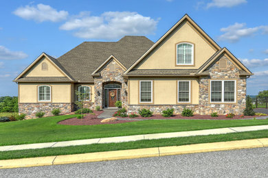 Example of a large classic beige two-story stone exterior home design in Baltimore with a shingle roof