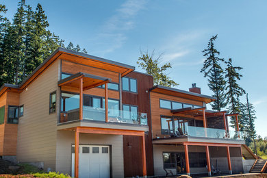 Example of a minimalist three-story wood exterior home design in Seattle